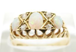 Edwardian 18ct gold ring set with three opal cabochons and four old cut diamonds, London 1907 (