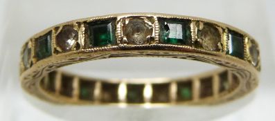 A 9ct gold eternity ring set with alternating green and clear paste, 2.4g (size M)