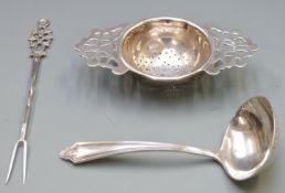 Hallmarked silver tea strainer, hallmarked silver sifter spoon and a continental white metal