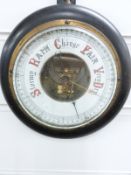 A late 19th/early 20thC circular aneroid barometer, the enamelled dial with red and black