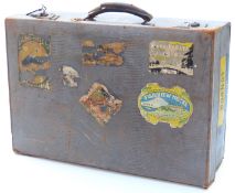 1930s suitcase with pale blue embossed lizard skin decoration and original travellers' labels