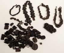 A collection of Victorian jet jewellery including a carved necklace, loose carved beads, a