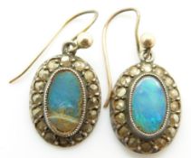 A pair of earrings set with black opal doublets and marcasite