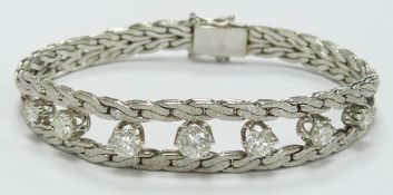 A 14ct white gold bracelet set with seven round brilliant cut diamonds measuring approximately 0.