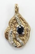 A yellow metal bi-coloured nugget style pendant set with an oval cut sapphire and diamonds, 13.1g,