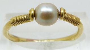 A 19thC yellow metal ring set with a pearl (size M)