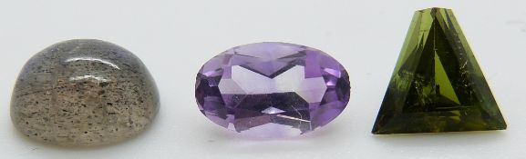 A labradorite cabochon, oval cut amethyst and a triangular cut tourmaline