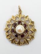 A 9ct gold pendant set with a pearl and garnets, diameter 2cm