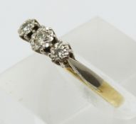 An 18ct gold ring set with three diamonds in a platinum setting (size L)