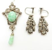 A silver pendant set with paste and a pair of silver earrings set with paste