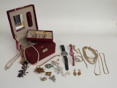 A collection of costume jewellery including brooches, necklaces, Emporio Armani watch, silver curb
