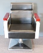Retro barber's chair with chrome base and supports to arms with black and white leather covering and