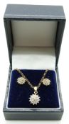 A 9ct gold pendant set with diamonds and matching earrings