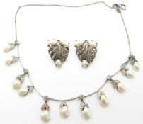 A necklace set with marcasite and blister pearls together with matching clips