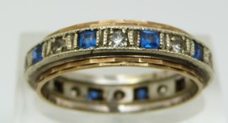 A 9ct gold eternity ring set with alternating blue and clear paste, 3.3g (size O)
