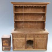 Two apprentice made pieces of furniture comprising an inlaid oriental style cupboard and dresser