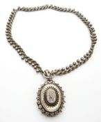 Victorian hallmarked silver locket with foliate and star decoration, on original chain with sphere