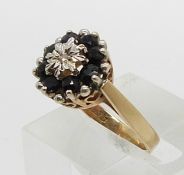 A 9ct gold ring set with sapphires and a diamond in a cluster (size M)