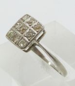 A platinum ring set with nine old cut diamonds in a square setting (size K/L)