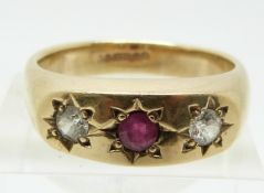 A 9ct gold ring set with a ruby and a cubic zirconia in star settings, 8.8g (size V)