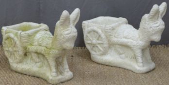A pair of garden models of donkeys pulling carts, length 59cm