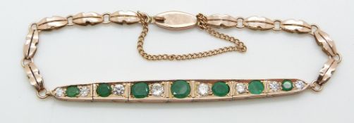 A rose gold Edwardian bracelet set with emeralds and diamonds, largest emerald 0.4ct, largest