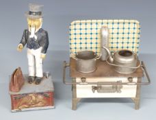 An early 20thC tin plate toy cooking range LP-N to oven door, paraffin burners inside complete