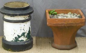 Two chimney pots, one upturned to form a garden planter