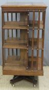 Large oak revolving bookcase with slatted sides raised ion rotating base, W59 x H118cm