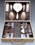 Asprey cased hallmarked silver travelling set comprising hand mirror, four brushes and silver lidded