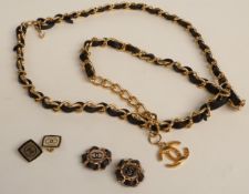 A gold tone Chanel belt with black leather detail with two pairs of Chanel earrings