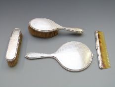 Walker and Hall four piece hallmarked silver dressing table set comprising hand mirror, two
