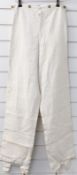 A pair of 19thC canvas breeches / trousers with engraved brass buttons