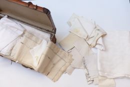 A vintage ash bound suitcase containing a quantity of linen and lace including heavy damask