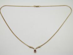 A 9ct gold necklace set with a ruby and diamond