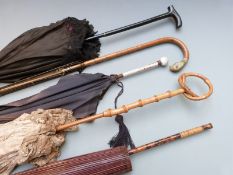 Five Edwardian parasols including lace examples, one with carved parrot handle, Japanese etc