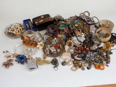 A collection of costume jewellery including beads, vintage earrings, vintage brooches, lacquer