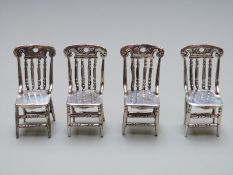 Set of four white metal novelty miniature chairs, each stamped 925, height 39mm, weight of all