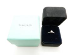 A platinum Tiffany ring set with a round cut diamond of approximately 0.33ct, in original box (
