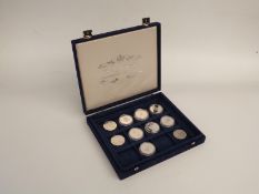 Ten crown sized coins including silver, maple leaf, Britannia etc