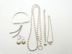 A silver necklace, three silver bracelets and a pair of silver earrings