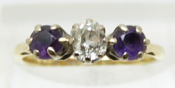 An 18ct gold ring set with an old cut diamond of approximately 0.3ct and two amethysts (size K)