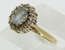 A 9ct gold ring set with an aquamarine and cubic zirconia  (size M)
