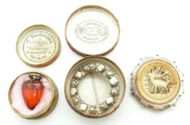 A silver brooch, a heart pendant and a silver and bone brooch