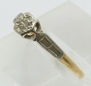 An 18ct gold ring set with a diamond in a platinum setting (size L)