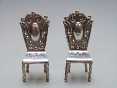 A pair of novelty miniature white metal chairs, each stamped 925, height 55mm, weight 24g