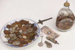 A collection of UK and overseas coins, British Rail whistles etc on a blue and white dish, small