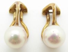 A pair of 14ct gold earrings set with a pearl to each