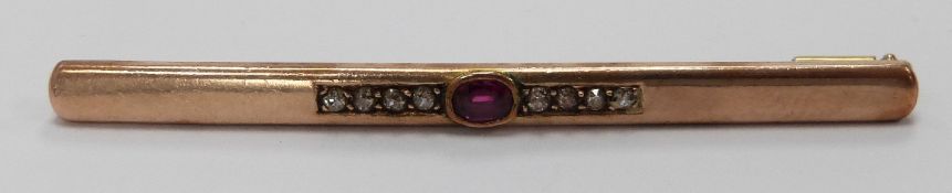 A 14ct gold brooch set with an oval cut ruby and old cut diamonds
