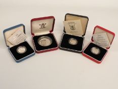A silver Vanuatu crown, Alderney £1 coin and two UK silver proof £1 coins for 1996 and 2000